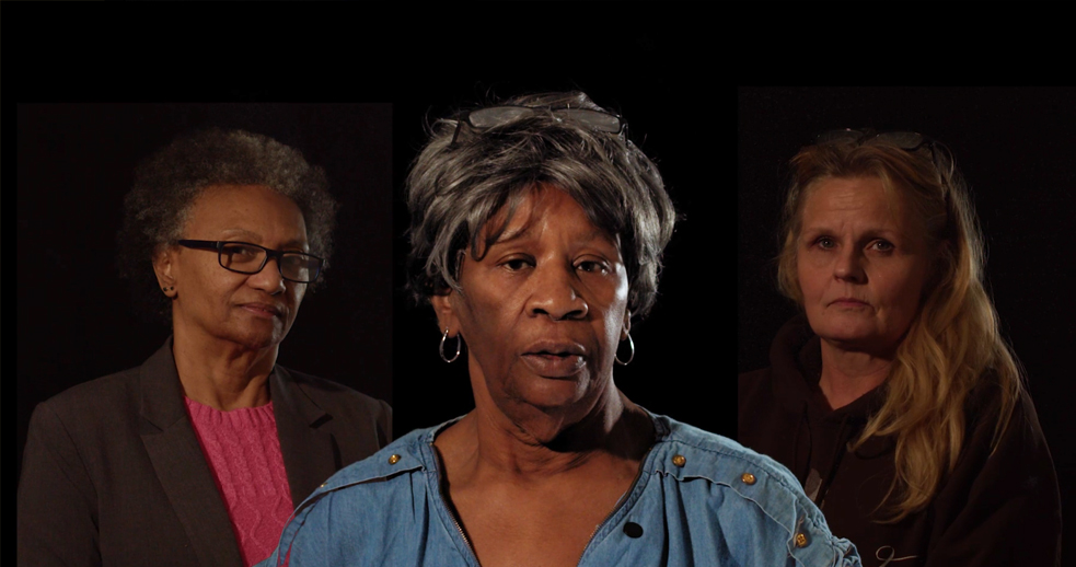 Three women on a black background looking at the camera